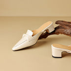 "Marloe Spitz zulaufende Leder-Mules" can be rewritten as "Marloe Elegante Spitz zulaufende Leder-Mules".