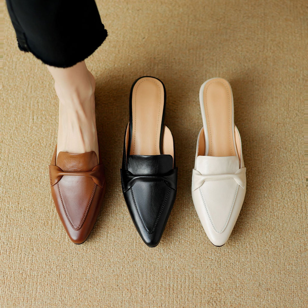 "Marloe Spitz zulaufende Leder-Mules" can be rewritten as "Marloe Elegante Spitz zulaufende Leder-Mules".